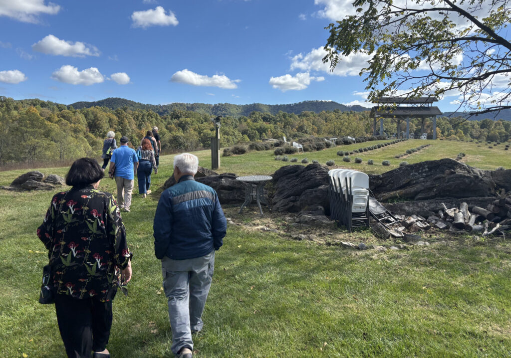 Several travel journalists taking a stroll around the hillside at Beliveau Farm Winery.