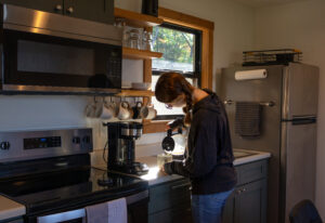 Woman pours coffee at Gap Mountain Retreat